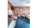 Living area features wood-look walls, comfortable seating, and kitchenette setup at 4589 Prices Bridge Ln, Walterboro, SC 29488