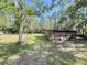 Outbuilding surrounded by mature trees and lush lawn offering quiet retreat within property at 4589 Prices Bridge Ln, Walterboro, SC 29488