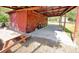 Red outbuilding with covered patio and concrete floor in a lush yard with picnic table at 4589 Prices Bridge Ln, Walterboro, SC 29488