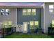 Rear exterior of the property showcasing siding, windows, and access to the backyard at 493 Trotters Ln, Moncks Corner, SC 29461