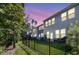 Fenced backyard offering privacy and a view of the townhomes at dusk at 493 Trotters Ln, Moncks Corner, SC 29461