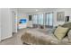 Bright bedroom featuring comfortable bedding, soft colors, and natural light from three large windows at 493 Trotters Ln, Moncks Corner, SC 29461