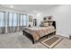 Cozy bedroom showcasing plush bedding, neutral decor, and ample natural light from the windows at 493 Trotters Ln, Moncks Corner, SC 29461