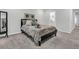 Well-lit bedroom with an ensuite bathroom entrance with calm and neutral decor at 493 Trotters Ln, Moncks Corner, SC 29461