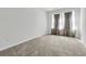 Bright bedroom with neutral carpet, large windows with curtains, and ample natural light at 493 Trotters Ln, Moncks Corner, SC 29461
