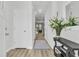 Inviting entryway with light wood floors, white doors, a decorative console table, and a mirror at 493 Trotters Ln, Moncks Corner, SC 29461