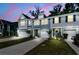 Charming townhomes feature attached garages and inviting curb appeal against a vibrant twilight sky at 493 Trotters Ln, Moncks Corner, SC 29461