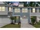 Two-story home showcasing a well-maintained lawn, attached garage, and inviting curb appeal at 493 Trotters Ln, Moncks Corner, SC 29461