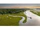 Beautiful aerial view of a waterfront property with a long dock extending into the marsh at 510 Traders Aly, Mount Pleasant, SC 29464