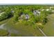 An amazing aerial view of a beautiful luxury home surrounded by lush greenery and waterfront at 510 Traders Aly, Mount Pleasant, SC 29464