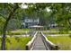 A home and backyard with a dock, gazebo, and seating area is situated at the end of a wooden walkway at 510 Traders Aly, Mount Pleasant, SC 29464
