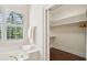 Bright bathroom featuring a soaking tub, walk-in closet, and window allowing for natural light to fill the space at 510 Traders Aly, Mount Pleasant, SC 29464