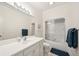Well-lit bathroom with a large mirror, white vanity, and a shower-tub combo with sliding glass doors at 510 Traders Aly, Mount Pleasant, SC 29464