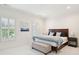 Bright bedroom featuring a dark wood bed frame, neutral colored walls, shutters, and a decorative bench at 510 Traders Aly, Mount Pleasant, SC 29464