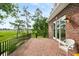 Spacious brick patio with black metal railing and scenic marsh views, great for outdoor relaxation at 510 Traders Aly, Mount Pleasant, SC 29464