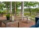 Relaxing covered patio with brick flooring, white columns, outdoor furniture, and scenic water views at 510 Traders Aly, Mount Pleasant, SC 29464