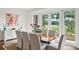 A dining room features a wood table with seating for six and a view of a marsh through the floor to ceiling windows at 510 Traders Aly, Mount Pleasant, SC 29464