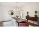 Formal dining room with modern chandelier, hardwood floors, and stylish wood and upholstered seating at 510 Traders Aly, Mount Pleasant, SC 29464
