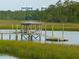 Waterfront dock with gazebo along marshland and trees, with cranes visible in the background at 510 Traders Aly, Mount Pleasant, SC 29464