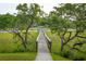View of dock and pier leading to waterfront property, with lush greenery at 510 Traders Aly, Mount Pleasant, SC 29464