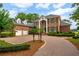 Stately brick home featuring manicured landscaping, a circular driveway, and a three-car garage at 510 Traders Aly, Mount Pleasant, SC 29464