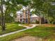 Beautiful brick home featuring a lush green lawn, mature trees, and a curved walkway leading to the entrance at 510 Traders Aly, Mount Pleasant, SC 29464