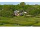 Brick home sits on waterfront property with lush greenery and a charming marsh view at 510 Traders Aly, Mount Pleasant, SC 29464