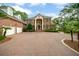 Grand brick home featuring a circular driveway and manicured landscaping at 510 Traders Aly, Mount Pleasant, SC 29464