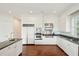 An open kitchen features white cabinets, stainless appliances, a hardwood floor, and granite countertops at 510 Traders Aly, Mount Pleasant, SC 29464