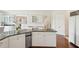 A kitchen has a granite countertop and stainless appliances, with a view of a work desk area and dining area at 510 Traders Aly, Mount Pleasant, SC 29464