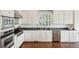 A modern kitchen features white cabinets, stainless steel appliances, a large window, and hardwood floors at 510 Traders Aly, Mount Pleasant, SC 29464