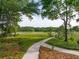 Landscaped path leads to a quaint bridge with water views, surrounded by lush trees and vegetation at 510 Traders Aly, Mount Pleasant, SC 29464
