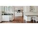 A living room features a white sofa and large built-in shelving, as viewed from a kitchenette with stone counters at 510 Traders Aly, Mount Pleasant, SC 29464