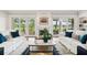 Open living room with hardwood floors, fireplace, comfortable seating, and access to outdoor patio at 510 Traders Aly, Mount Pleasant, SC 29464
