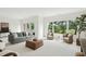 Spacious living room featuring a plush grey sofa, wicker chairs, and scenic outdoor views at 510 Traders Aly, Mount Pleasant, SC 29464