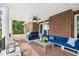 Covered outdoor patio with brick flooring, ample seating, ceiling fan, and outdoor grill at 510 Traders Aly, Mount Pleasant, SC 29464