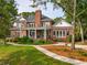Expansive brick home with a covered patio and manicured lawn at 510 Traders Aly, Mount Pleasant, SC 29464