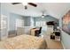 This is a cozy bedroom with an attached desk, ceiling fan, and built-in shelving at 518 Cecilia Cove Dr, Charleston, SC 29412