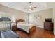 Primary bedroom with tray ceiling, ceiling fan, a treadmill and lots of natural light at 518 Cecilia Cove Dr, Charleston, SC 29412