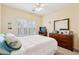 Cozy bedroom featuring plantation shutters, neutral paint, and a ceiling fan at 518 Cecilia Cove Dr, Charleston, SC 29412