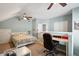 This is a cozy bedroom with an attached desk, ceiling fan, and a nautical-themed comforter set at 518 Cecilia Cove Dr, Charleston, SC 29412