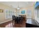 Dining room with plantation shutters, tray ceiling and dark wood furniture at 518 Cecilia Cove Dr, Charleston, SC 29412