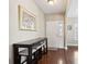 Inviting foyer area featuring hardwood floors, a large work desk, and a white front door at 518 Cecilia Cove Dr, Charleston, SC 29412