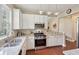 Modern kitchen boasts stainless steel appliances, granite countertops, and stylish pendant lighting at 518 Cecilia Cove Dr, Charleston, SC 29412