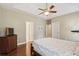Spacious main bedroom featuring hardwood floors, ceiling fan, and recessed tray ceiling at 518 Cecilia Cove Dr, Charleston, SC 29412