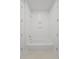 A simple tub and shower combination with white tiles offers a clean and functional design at 5710 Barbary Coast Rd, Hollywood, SC 29449