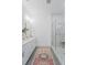 Bright bathroom featuring double vanity, decorative rug, and glass-enclosed shower with marbled tile at 5710 Barbary Coast Rd, Hollywood, SC 29449