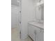 Powder room features a white vanity, countertop and modern mirror and light fixture at 5710 Barbary Coast Rd, Hollywood, SC 29449