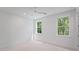 Bedroom features a ceiling fan and large windows that provide natural light and views at 5710 Barbary Coast Rd, Hollywood, SC 29449