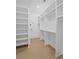 Spacious walk-in closet featuring custom shelving, and hardwood floors at 5710 Barbary Coast Rd, Hollywood, SC 29449